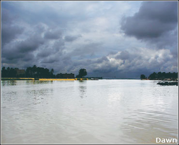 SUKKUR - August 2: A view of approaching clouds over still waters of the Indus.—Dawn