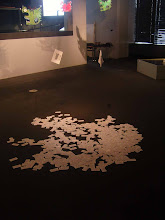 Holes from book on the floor. Visitors change the shape of that Island as they walk on it.