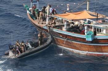 A team from HMS Chatham boards a dhow found to be carrying drugs. (Royal Navy Photo)