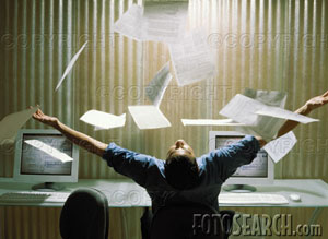 [man-seated-behind-computer-throwing-papers-in-the-air-rear-view-~-200020659-001.jpg]
