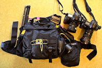 a bag and camera on a yellow surface