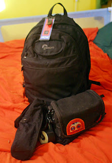 a black backpack on a bed