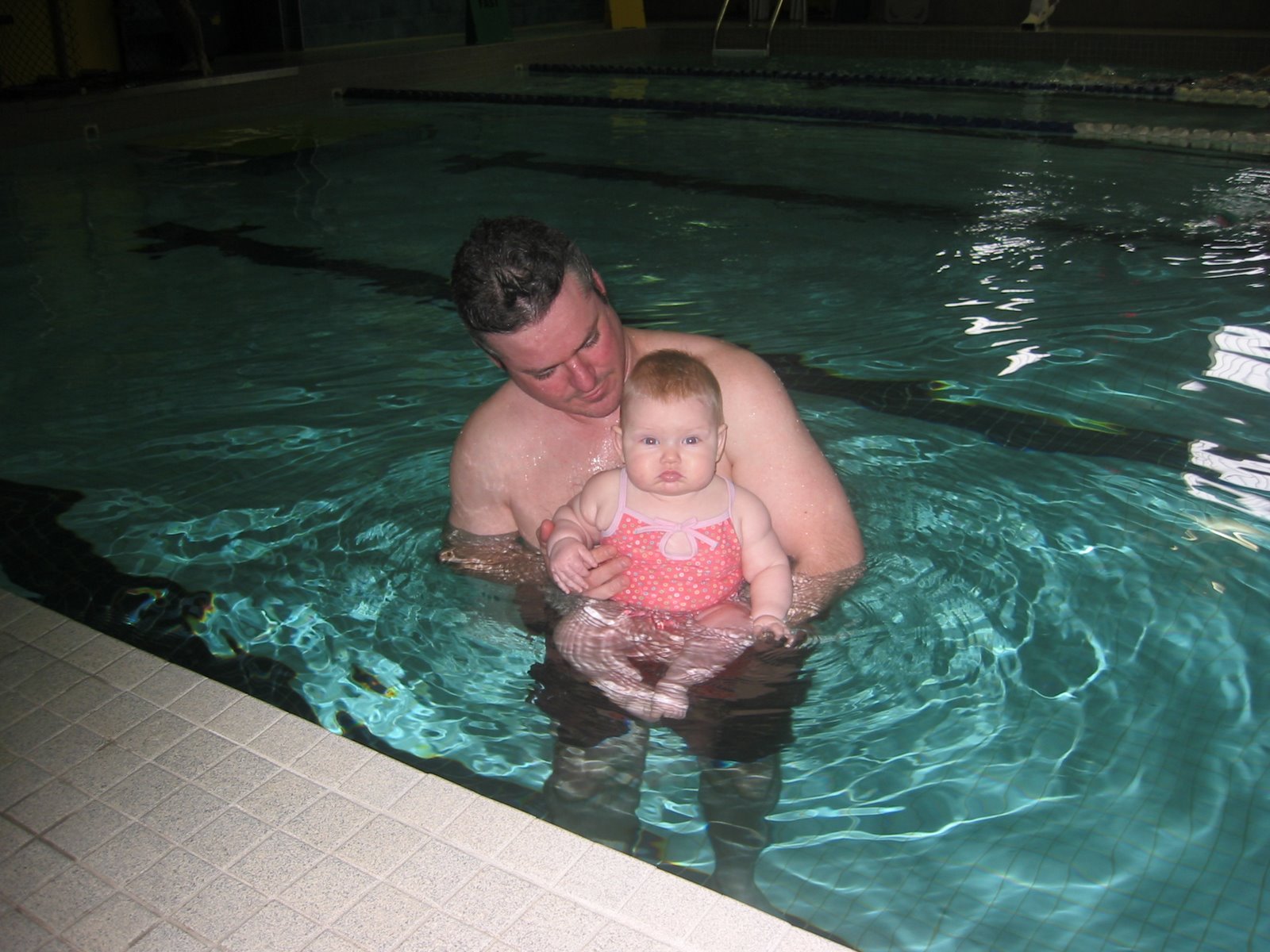 Mia going for a swim in the big pool with daddy