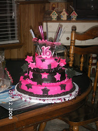 each tier is a white cake with hot pink and black swirl with butter cream frosting and fondant deco