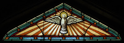 Immaculate Conception Roman Catholic Church, in Augusta, Missouri, USA - stained glass window of Holy Ghost as dove