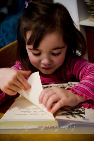 Little flipping thru pages at lifestyle kid portraits in Grass Valley, California