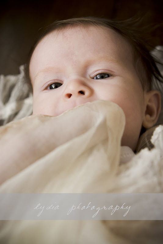 Baby with blanket in the mouth at lifestyle baby portraits in Grass Valley, California