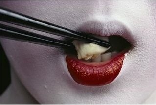 [Close-View-of-a-Geisha-Eating-Tofu-with-Chopsticks-Photographic-Print-C12454002.jpe]