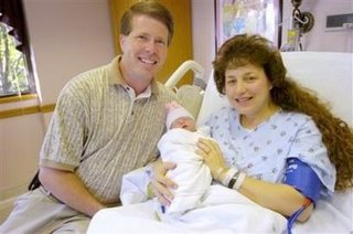 [Bob+Duggar+and+his+wife+Michelle+pose+at+a+Rogers,+Ark.,+hospital+as+she+holds+their+16th+child+Tuesday,+Oct.+11,+2005.jpg]