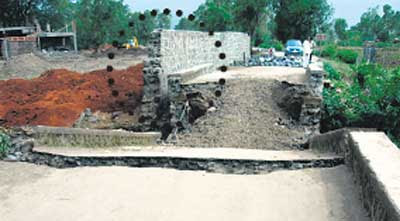 Bridge to Karjat Brooken alongside Mahadevan's wall