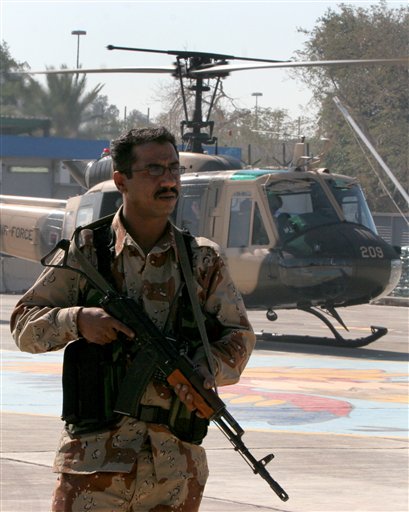 [Iraq.Iraqi+army+soldier+stands+guard+as+an+Iraqi+Air+Force+Huey+II+helicopter+lands+in+Baghdad2.jpg]