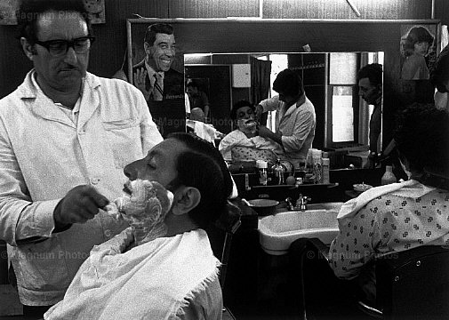 [Gueorgui+PinkhassovSOVIET+UNION.+Georgia.+Tbilissi.+1982.+Caucasian+men+like+to+be+shaved+once+or+twice+a+week.+In+this+barbershop+a+photo+of+the+French+actor+FERNANDEL+hangs+on+the+wall..jpg]