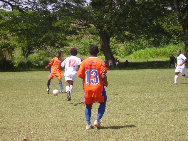 SANTOS' SWEEPER LUKE IN CONTROL OF THE BALL UP AGAINST A TELEKOM FC STRIKER