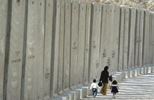 [A+Palestinian+woman+walking+beside+the+Sharon+Land-Grab+Wall,.jpg]