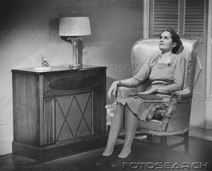 [woman-sitting-in-armchair-with-book-on-knees-bw-~-72131176.jpg]