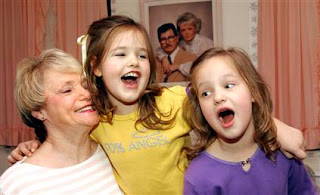 5-year-old twins Carli Sue Morgan, left, and Margaret Jan Marie, sing a silly song for their 63-year-old mother Judy Cates