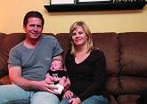 Bob and Kristin Valmes and their son Jacob, 8 weeks, in their home in Elk Grove Village