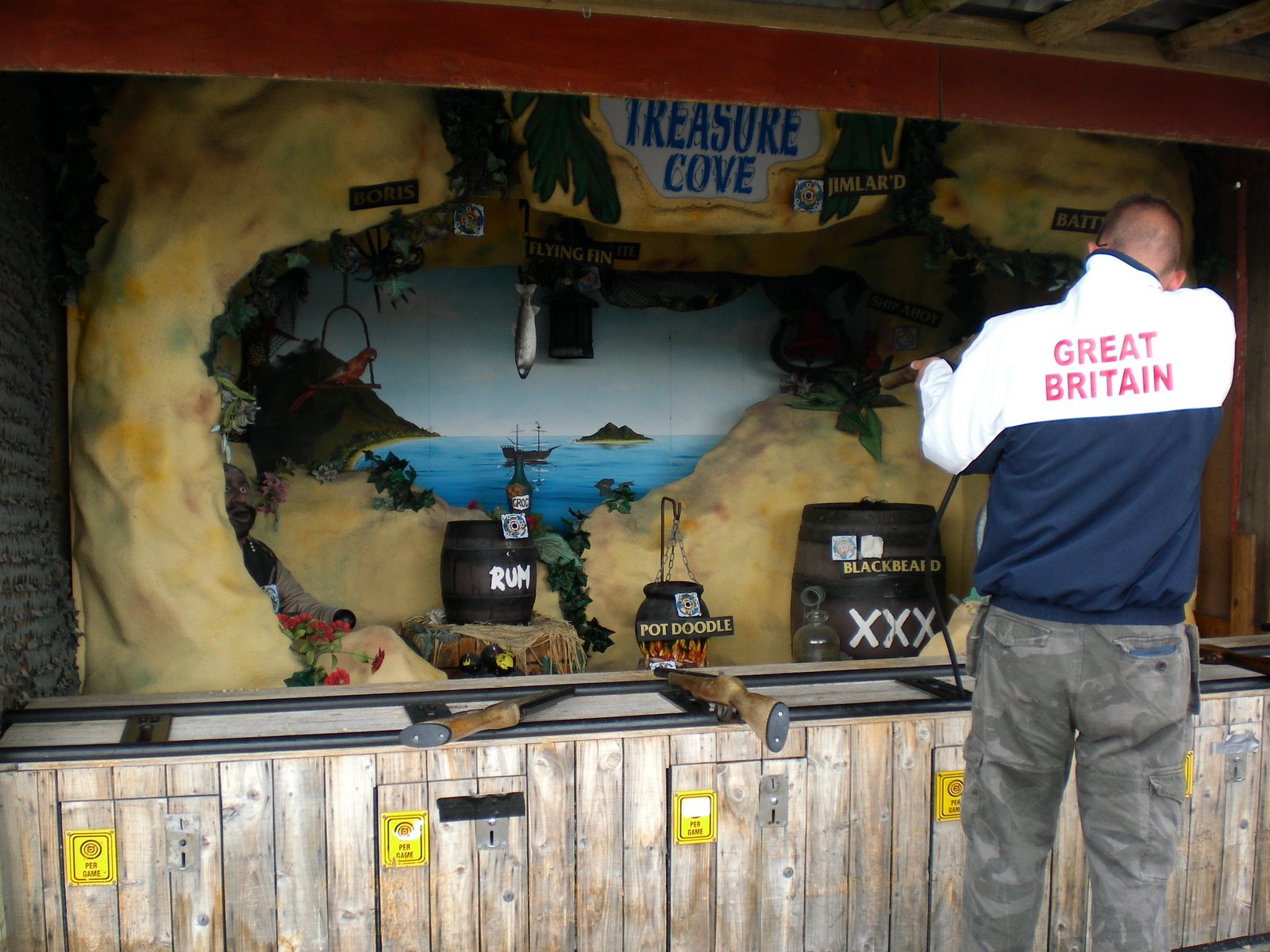 Playing the Treasure Cove shooting gallery at Blackbeard's Treasure Island in Eastbourne
