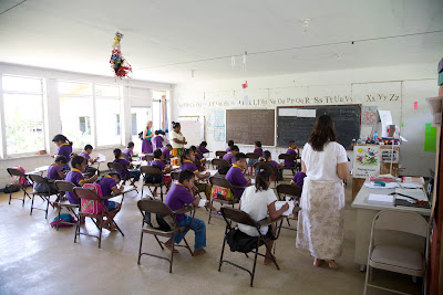 classroom with purple-clad students at desks