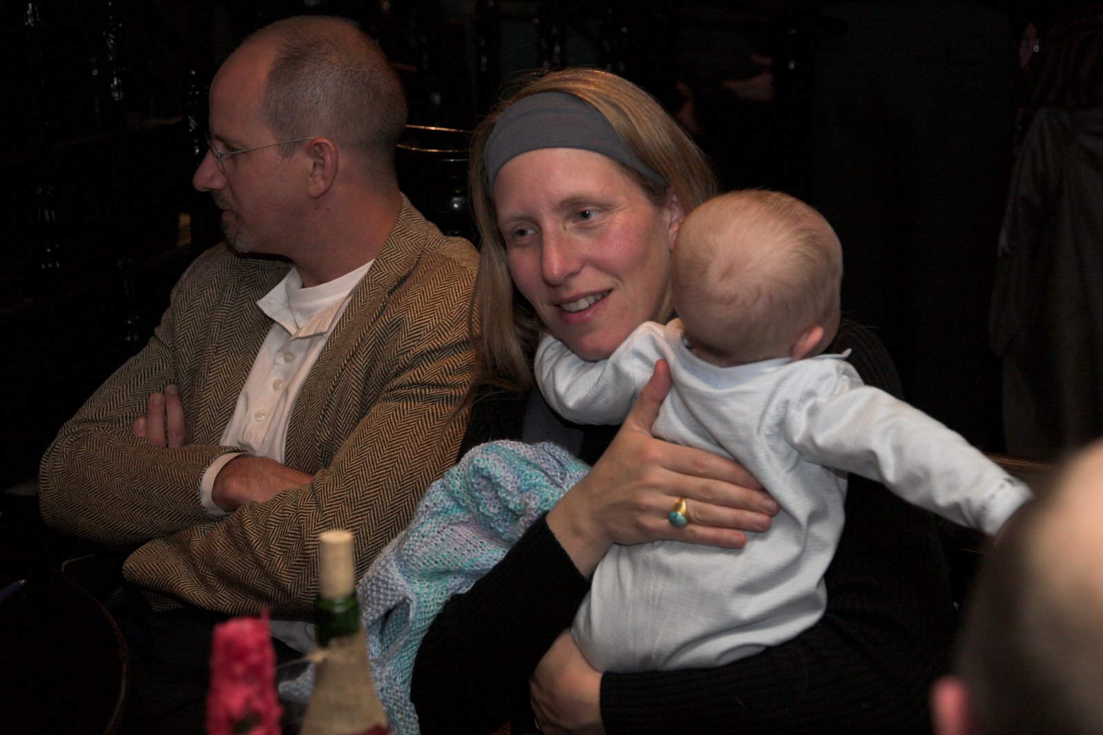 Nina Smith with baby, Will Foote in background
