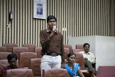 blind student speaking at seminar with microphone