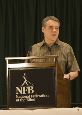 Craig Woods of Amazon.com at a podium that says NFB