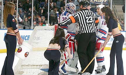 Lundqvist talks with the referee after he refused to let the ice girls clean the goal crease