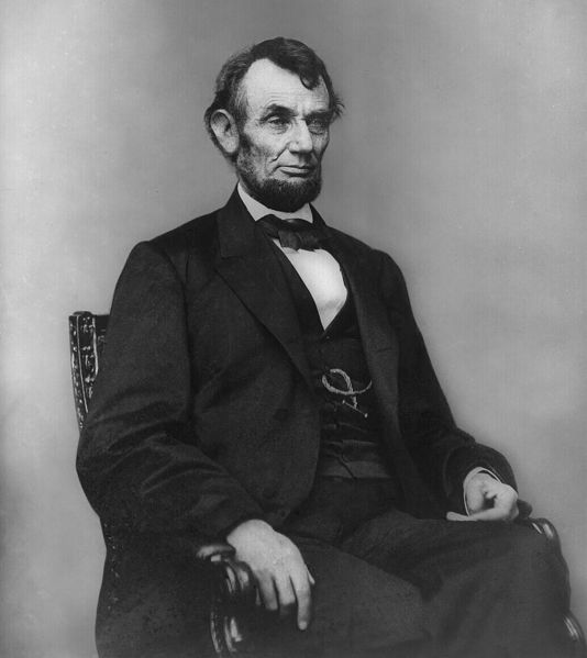 [534px-Abraham_Lincoln_seated%2C_Feb_9%2C_1864.jpg]