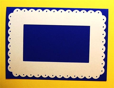 [scalloped+mat+with+holes+and+center+cut+out+on+blue+yellow+background.jpg]