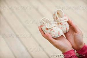 [woman-holding-baby-shoes-~-is874-020.jpg]