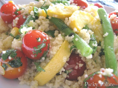 Close up of couscous tossed with garden vegetables.